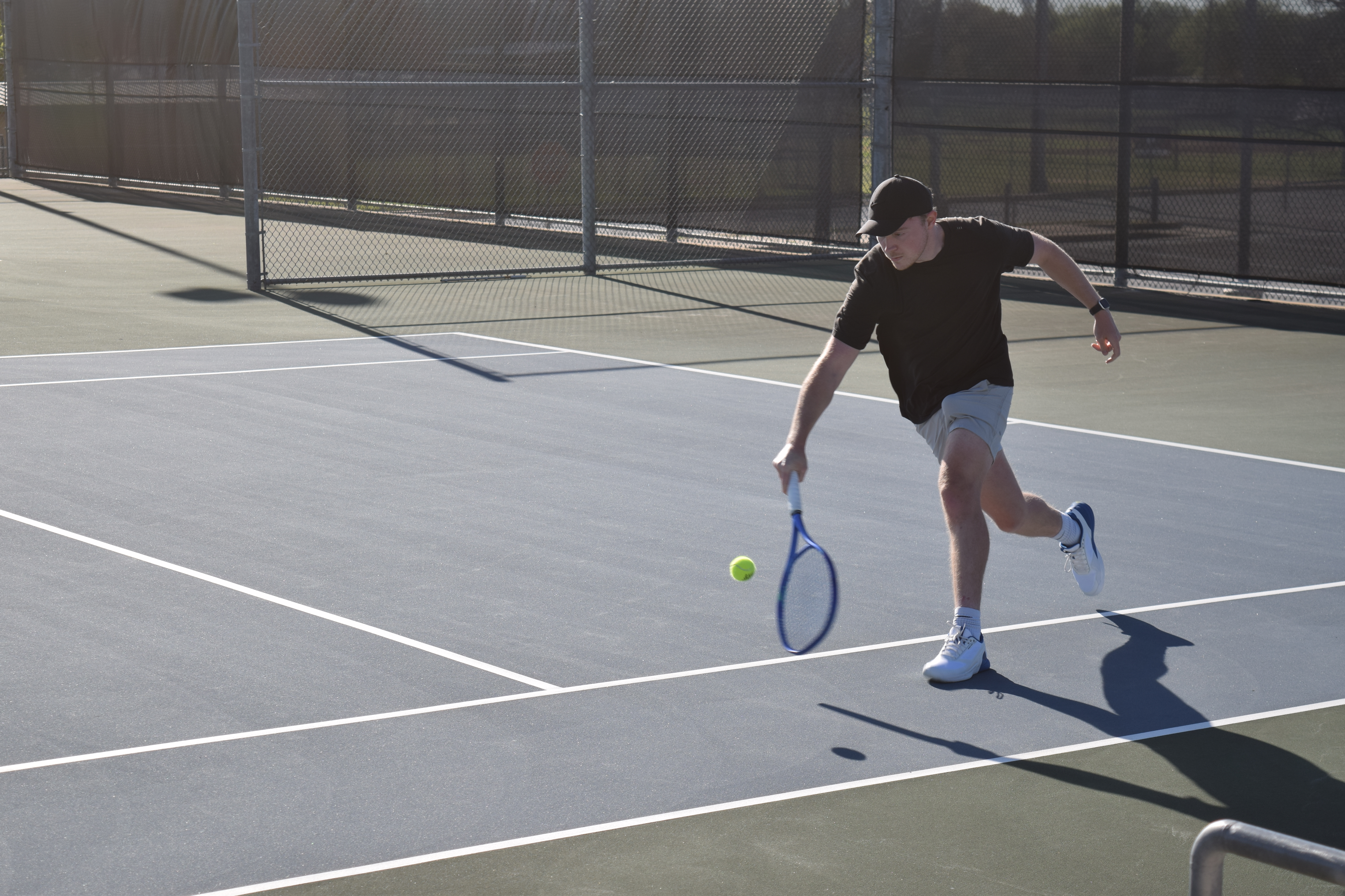 Alex playing tennis on an outdoor court